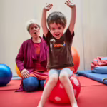 Das Bild zeigt einen kleinen Jungen bei der Physiotherapie.